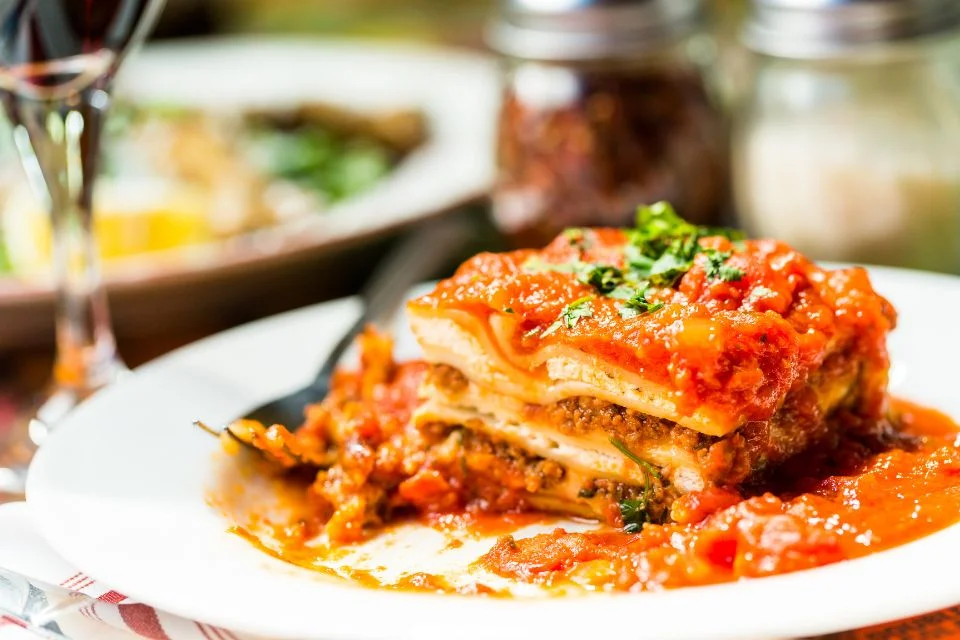 Lasagna is a large, flat spaghetti noodle often cooked in layers in the oven